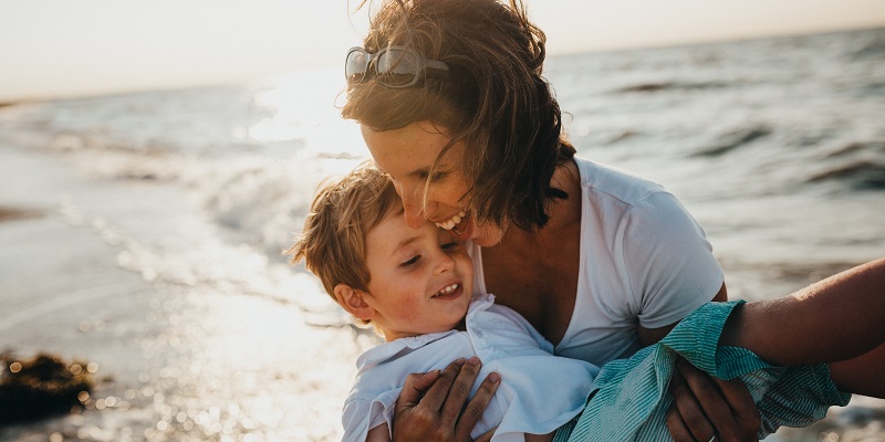 Mother and child playing on the camping beach