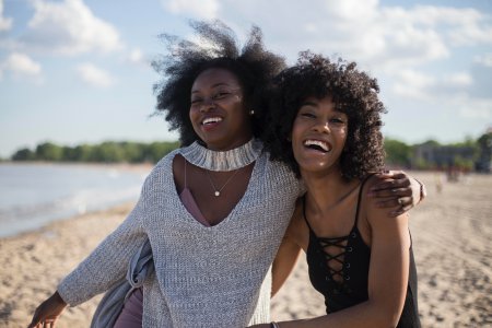 Two friends walking on the beach