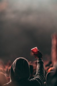 Person in a crow raising his cup