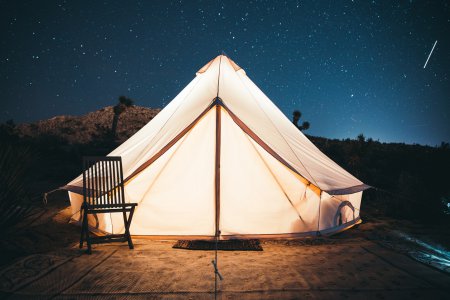 camping tent shining in a stary night. Beginner's camping gear