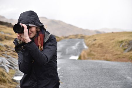 Girl taking picture of cold landscape