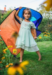 Little girl with a camping tent. Camping with kids tips.